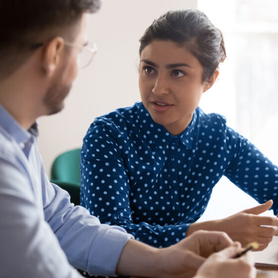 Two professionals in discussion about workforce solutions and SOW strategies