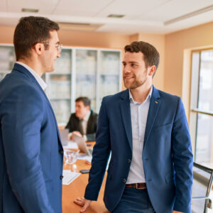 Two legal recruiters having a conversation in a modern office setting
