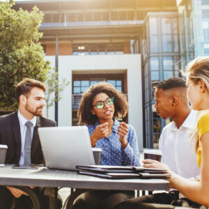 A team of technology professionals engages in a collaborative strategy session outdoors, showcasing innovation and teamwork. This image reflects the dynamic and inclusive talent we provide through our tech consulting and staffing services—delivering experienced consultants, developers, and IT leaders ready to generate ideas and transform business challenges into scalable solutions.