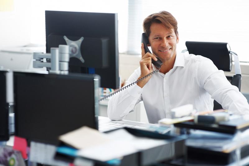 A data scientist speaks on the phone while working.