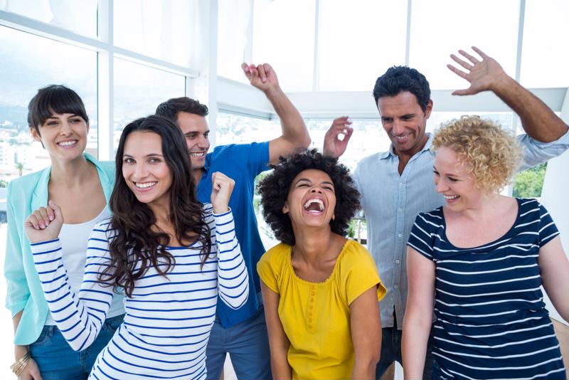A group of coworkers celebrating in the office.