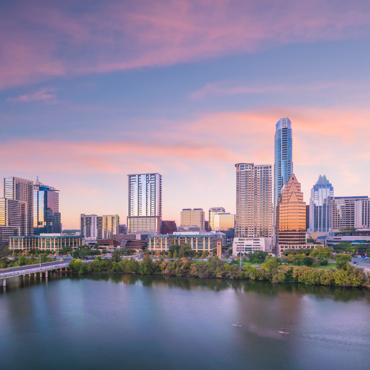 Austin skyline at sunset, featuring modern high-rise buildings along the river. A scenic view of downtown Austin, a hub for business growth, recruitment, and staffing solutions. Ideal for companies seeking staffing in Austin.