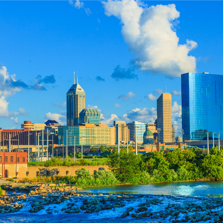Skyline of downtown Indianapolis, Indiana with a river in the foreground, representing the city’s vibrant environment for Indiana staffing solutions.
