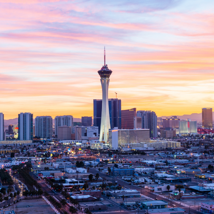 A panoramic sunset view of the Las Vegas skyline, featuring the iconic Stratosphere Tower and surrounding cityscape, representing the vibrant business hub of Las Vegas and its reputation as a top legal staffing agency destination.